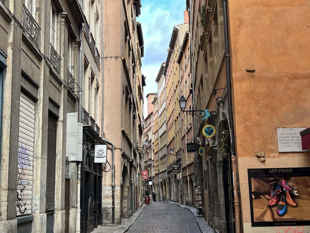 Cobblestone pedestrian street in the UNESCO World Heritage district of Vieux Lyon lined with Renaissance stone buildings built between 1450 and 1590.