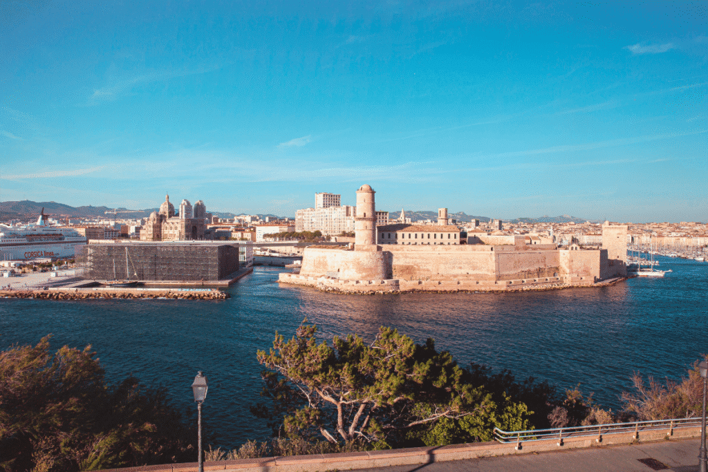 Panoramic view of Fort Saint-Jean overlooking the harbor in Marseille, with the modern MuCEM museum and Marseille Cathedral in the background, a highlight to include on any Marseille itinerary