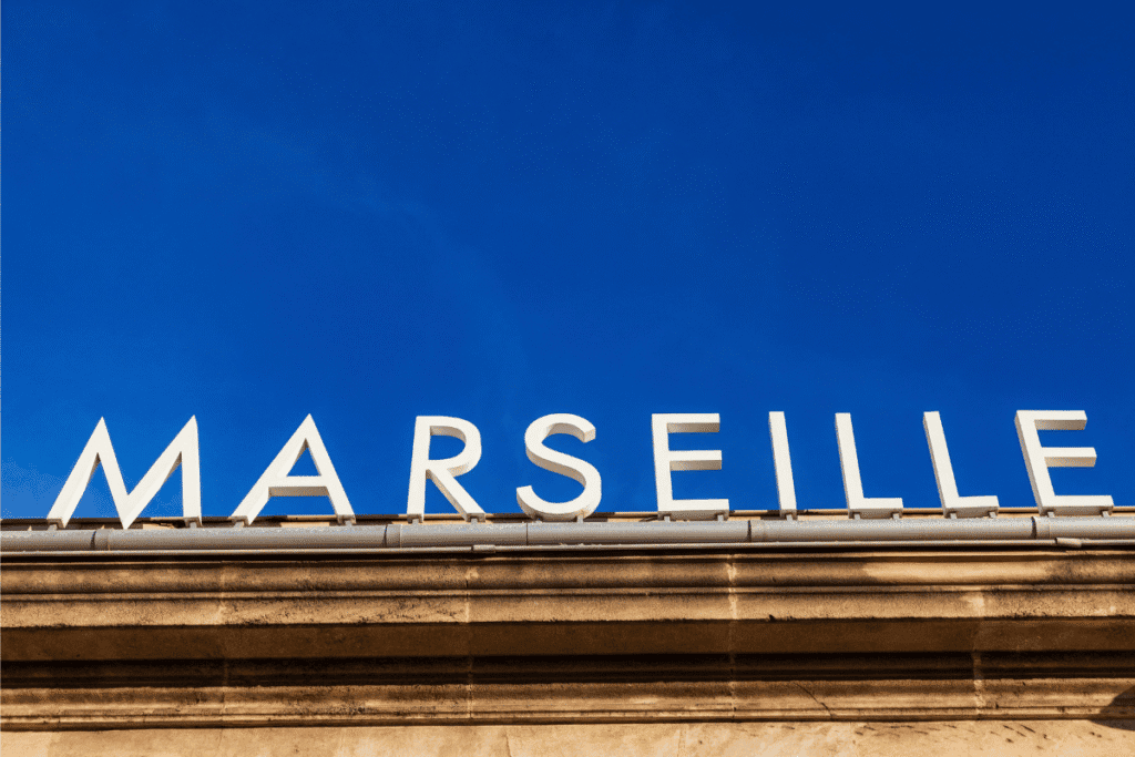 Large white letters spelling “Marseille” sit on top of a stone building against a clear blue sky. This bold city sign captures the welcoming spirit of southern France and reflects why Marseille is worth visiting for its culture, history, and seaside charm.