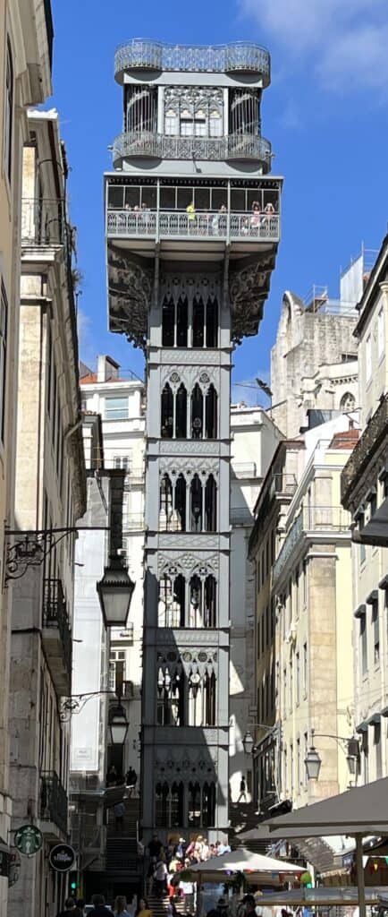 Santa Justa Lift rises above Lisbon’s streets with ornate ironwork and a viewing platform where visitors gather at the top. The unique elevator offers panoramic city views and is a popular stop on a 3 day itinerary Lisbon.
