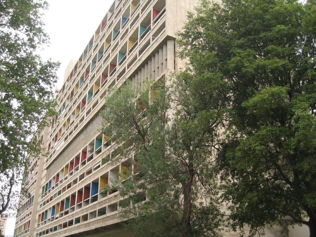 Exterior view of Cité Radieuse, a UNESCO World Heritage Site in Marseille showing Le Corbusier concrete architecture and colorful balcony panels.