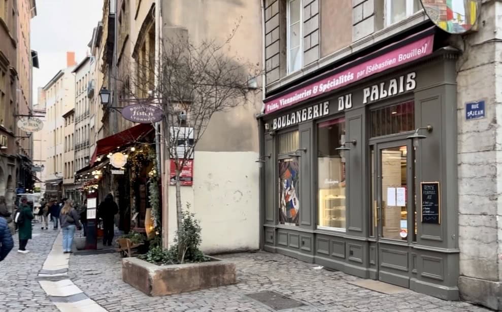 Narrow cobblestone street in Vieux Lyon with Boulangerie in foreground.