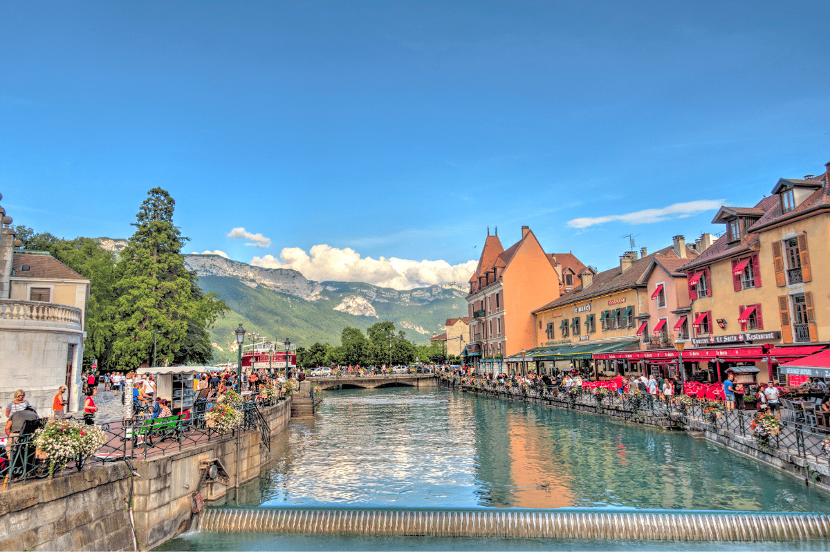 Annecy and its canals with the French Alps in the background on a day trip from Lyon France
